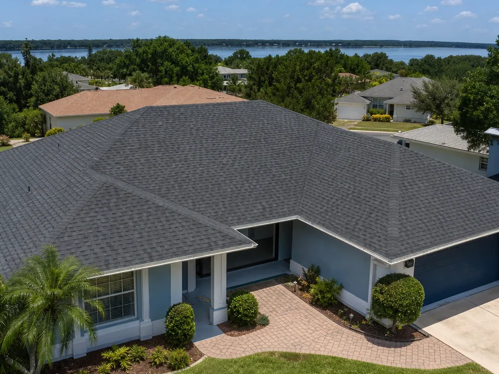 Completed architectural shingle roof with straight courses and cleanly capped hips and ridges